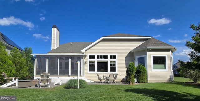 35516 Hedgerow Ln, Rehoboth Beach, DE 19971 - back of property featuring a lawn, a patio area, a sunroom, and roof with shingles