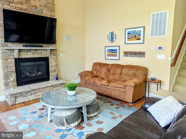 35516 Hedgerow Ln, Rehoboth Beach, DE 19971 - living area with wood finished floors, stairway, baseboards, and a stone fireplace