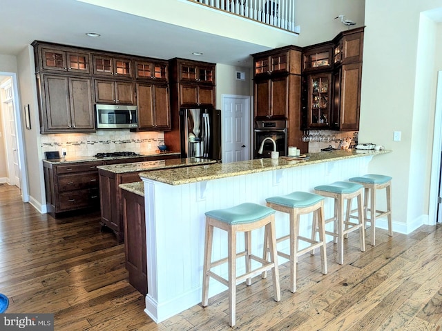 35516 Hedgerow Ln, Rehoboth Beach, DE 19971 - kitchen featuring stainless steel appliances, dark wood-type flooring, tasteful backsplash, and recessed lighting