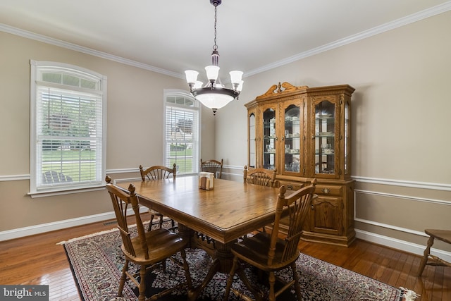 6422 Hard Bargain Cir, Indian Head, MD 20640 - dining space with a chandelier, crown molding, dark wood-type flooring, and baseboards