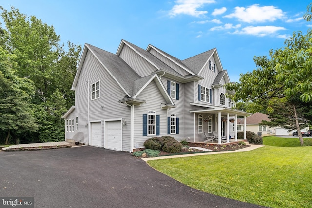 6422 Hard Bargain Cir, Indian Head, MD 20640 - view of front facade featuring covered porch, a garage, driveway, a front lawn, and a shingled roof
