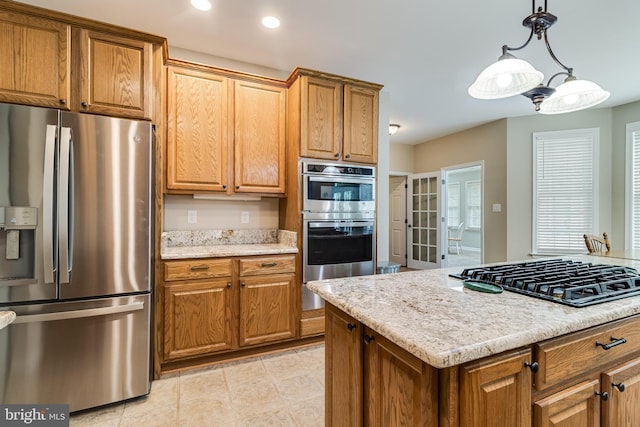 6422 Hard Bargain Cir, Indian Head, MD 20640 - kitchen featuring stainless steel appliances, brown cabinets, light stone countertops, hanging light fixtures, and recessed lighting