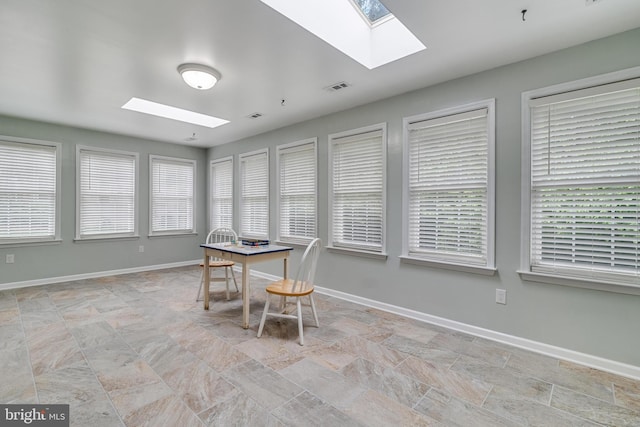 6422 Hard Bargain Cir, Indian Head, MD 20640 - dining room featuring a skylight, stone finish flooring, plenty of natural light, and baseboards