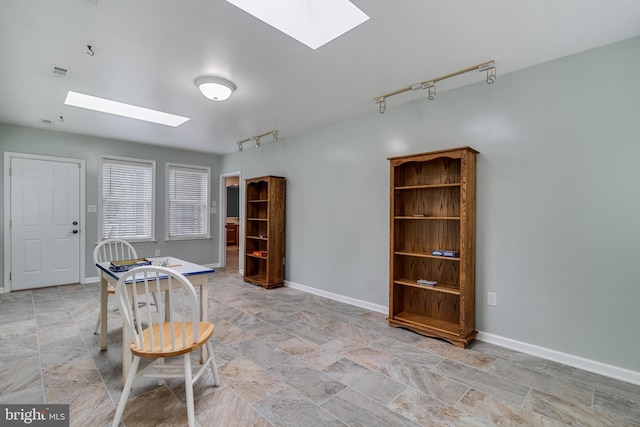 6422 Hard Bargain Cir, Indian Head, MD 20640 - dining space featuring a skylight, track lighting, light stone finish floors, and baseboards