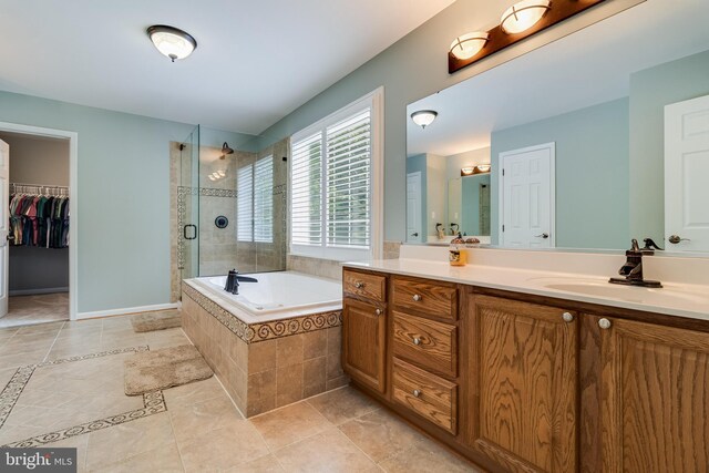 6422 Hard Bargain Cir, Indian Head, MD 20640 - bathroom with double vanity, a shower stall, a garden tub, tile patterned flooring, and baseboards