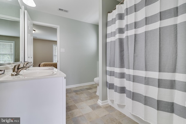 6422 Hard Bargain Cir, Indian Head, MD 20640 - bathroom featuring vanity, toilet, baseboards, and a shower with curtain