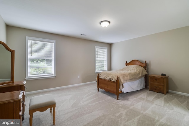 6422 Hard Bargain Cir, Indian Head, MD 20640 - bedroom with multiple windows, light carpet, and baseboards