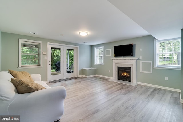 6422 Hard Bargain Cir, Indian Head, MD 20640 - living room with light wood-style flooring, a fireplace, and baseboards