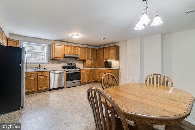 6422 Hard Bargain Cir, Indian Head, MD 20640 - kitchen featuring stainless steel appliances, a sink, under cabinet range hood, and light countertops