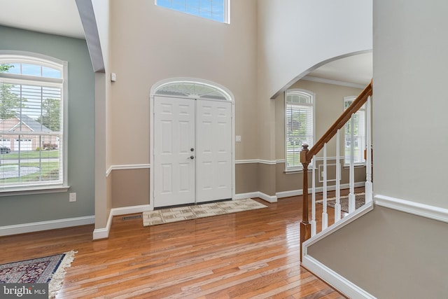 6422 Hard Bargain Cir, Indian Head, MD 20640 - entrance foyer with arched walkways, hardwood / wood-style flooring, healthy amount of natural light, baseboards, and a high ceiling