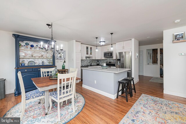 706 Melvin Rd, Telford, PA 18969 - dining room with a chandelier, light wood-style flooring, and baseboards
