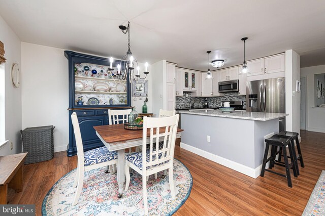 706 Melvin Rd, Telford, PA 18969 - dining space with wood finished floors, baseboards, and a chandelier