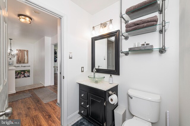 706 Melvin Rd, Telford, PA 18969 - bathroom with wood finished floors, vanity, toilet, a chandelier, and baseboards