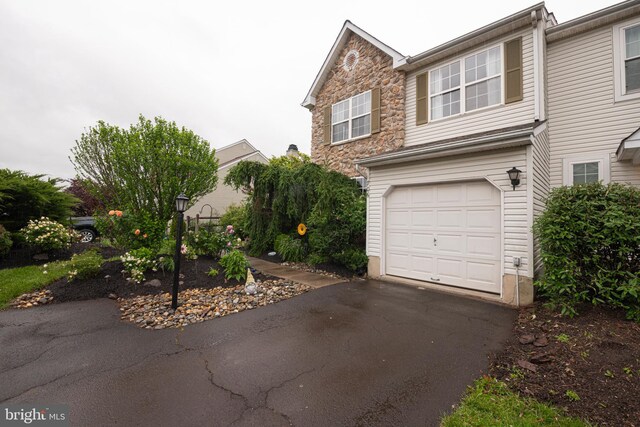 706 Melvin Rd, Telford, PA 18969 - view of front of home with an attached garage, stone siding, and asphalt driveway