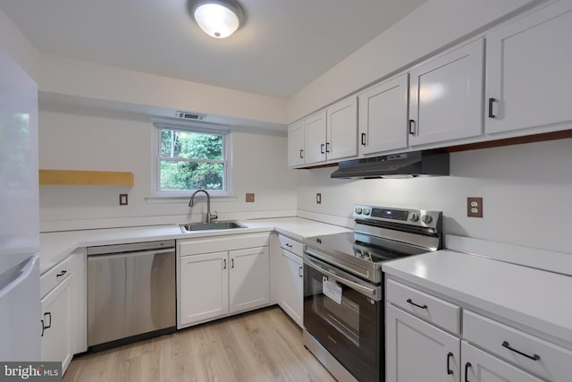 1134 Fox Run, Reading, PA 19606 - kitchen featuring stainless steel appliances, under cabinet range hood, a sink, white cabinets, and light countertops