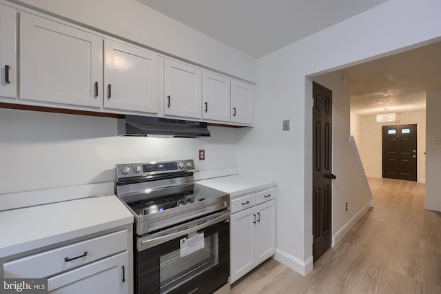 1134 Fox Run, Reading, PA 19606 - kitchen featuring electric range, under cabinet range hood, light wood-style floors, and light countertops