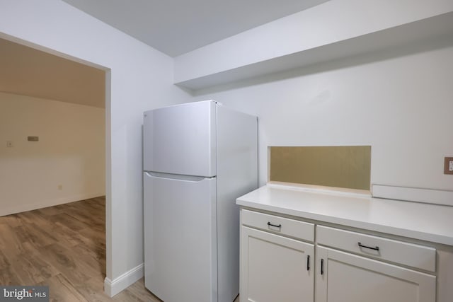 1134 Fox Run, Reading, PA 19606 - kitchen with freestanding refrigerator, light wood finished floors, light countertops, and white cabinets