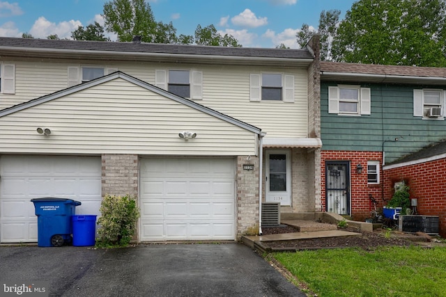 1134 Fox Run, Reading, PA 19606 - multi unit property with asphalt driveway, brick siding, cooling unit, and a garage