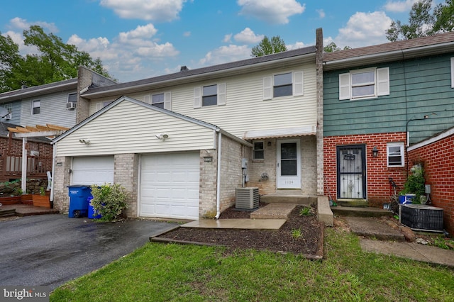 1134 Fox Run, Reading, PA 19606 - view of front facade with asphalt driveway, central AC, an attached garage, and brick siding