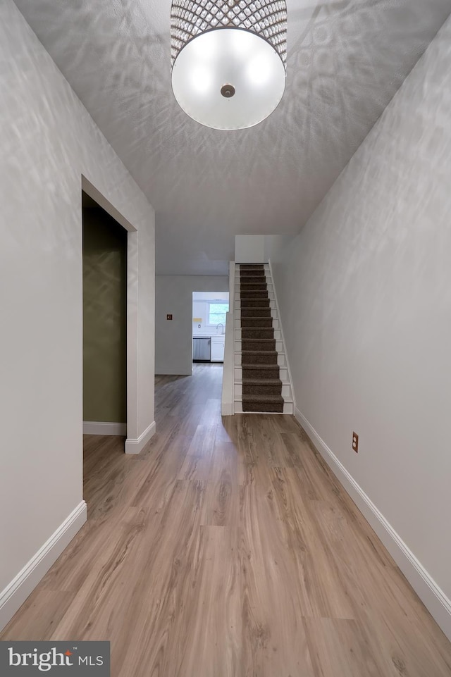 1134 Fox Run, Reading, PA 19606 - unfurnished living room featuring stairs, baseboards, and wood finished floors