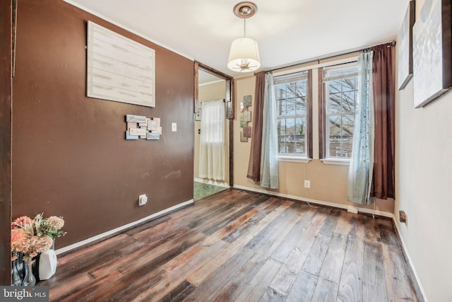 904 N Rosedale St, Baltimore, MD 21216 - unfurnished dining area with wood-type flooring and baseboards