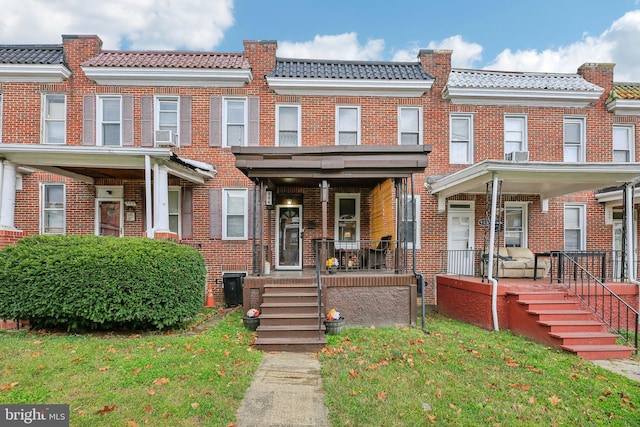 904 N Rosedale St, Baltimore, MD 21216 - multi unit property featuring a tile roof, a porch, brick siding, and a front yard
