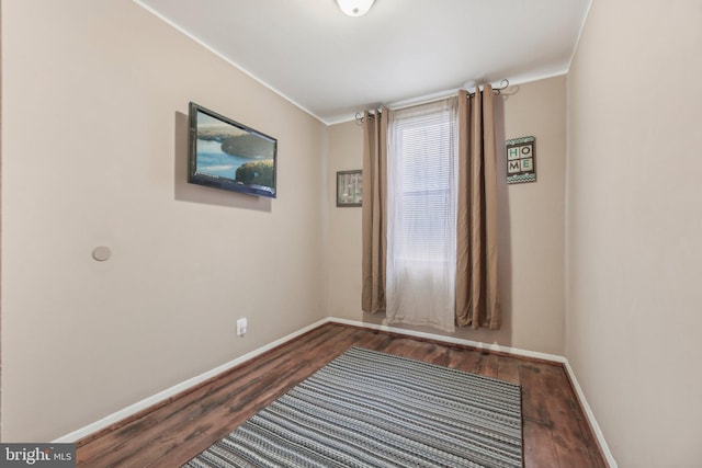 904 N Rosedale St, Baltimore, MD 21216 - spare room featuring crown molding, wood finished floors, and baseboards