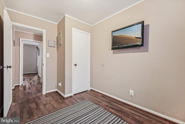 904 N Rosedale St, Baltimore, MD 21216 - unfurnished bedroom with wood finished floors, baseboards, and crown molding