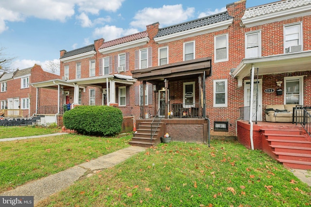 904 N Rosedale St, Baltimore, MD 21216 - view of property featuring covered porch, brick siding, and a tiled roof