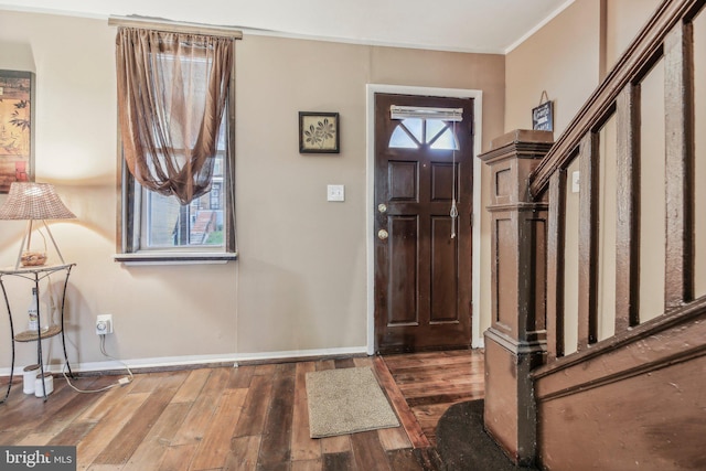 904 N Rosedale St, Baltimore, MD 21216 - foyer entrance with baseboards, wood finished floors, and crown molding