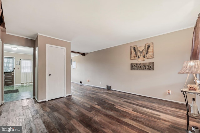 904 N Rosedale St, Baltimore, MD 21216 - unfurnished living room with dark wood-style flooring, baseboards, and crown molding