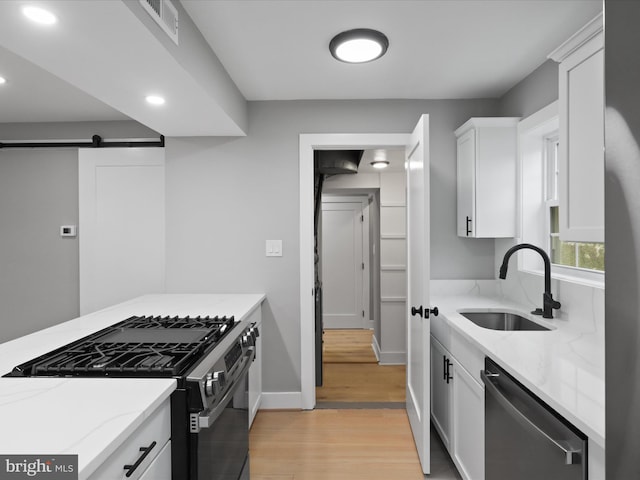 5105 11th St S, Arlington, VA 22204 - kitchen featuring stainless steel appliances, a sink, light stone counters, recessed lighting, and light wood-style floors
