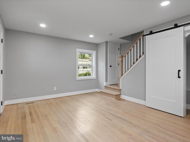 5105 11th St S, Arlington, VA 22204 - basement with a barn door, wood-type flooring, baseboards, stairs, and recessed lighting