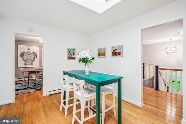 3117 Port Way, Annapolis, MD 21403 - dining space with light wood-style flooring, a chandelier, baseboards, and a skylight
