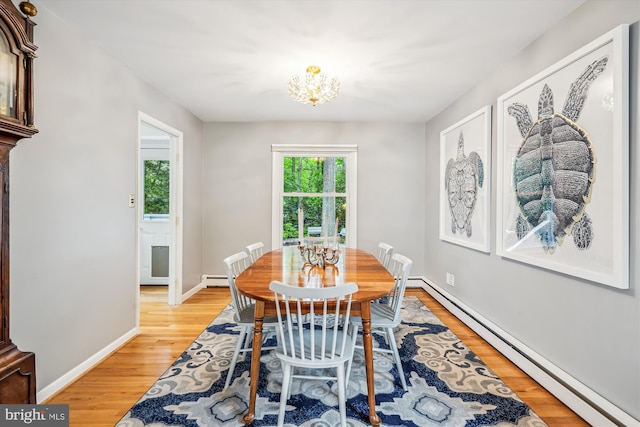 3117 Port Way, Annapolis, MD 21403 - dining area featuring baseboard heating, light wood-type flooring, a chandelier, and baseboards
