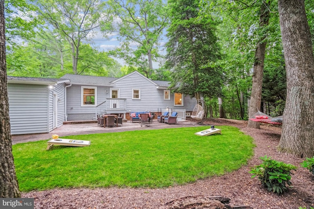 3117 Port Way, Annapolis, MD 21403 - rear view of house with a patio, a lawn, outdoor lounge area, and roof with shingles