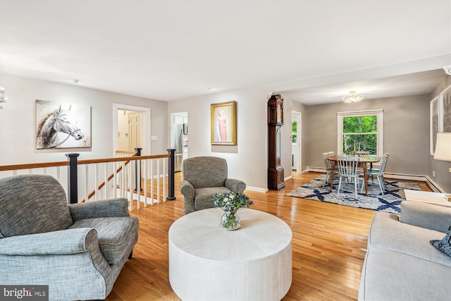 3117 Port Way, Annapolis, MD 21403 - living room with baseboards, light wood-style flooring, a chandelier, and a baseboard radiator