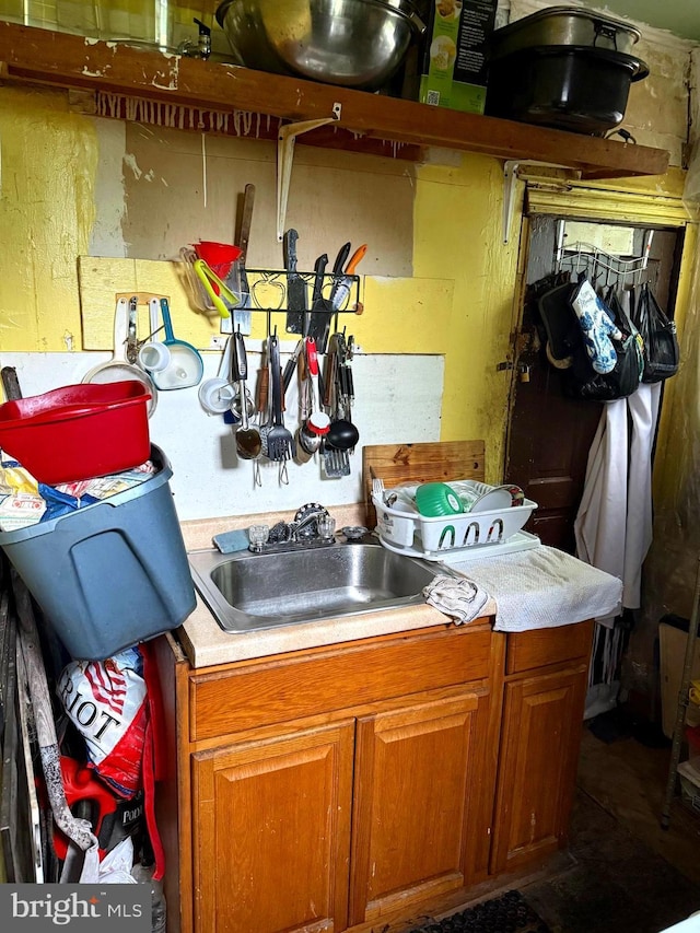2122 W Toronto St, Philadelphia, PA 19132 - kitchen featuring brown cabinetry, a sink, and light countertops