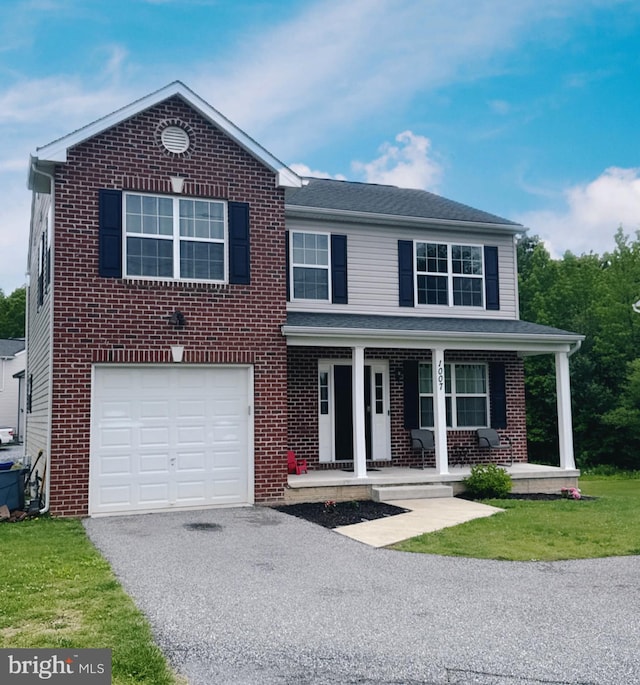 1007 Wampler Rd, Middle River, MD 21220 - traditional-style home with asphalt driveway, a garage, covered porch, brick siding, and a front lawn