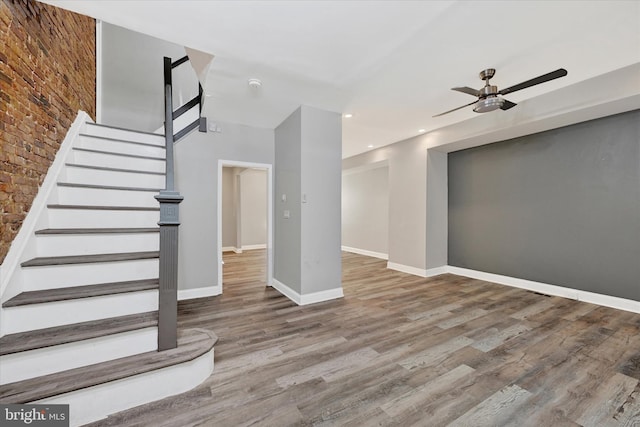 405 N Loudon Ave, Baltimore, MD 21229 - staircase with a ceiling fan, wood finished floors, baseboards, recessed lighting, and brick wall
