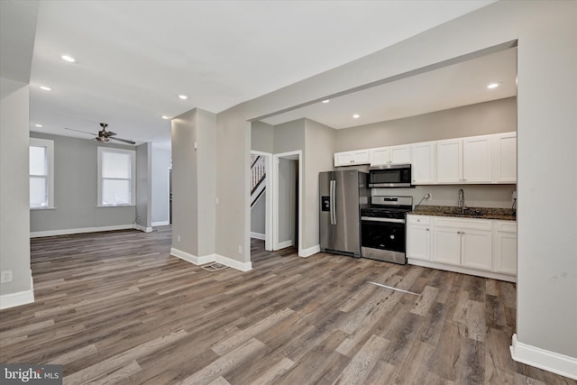 405 N Loudon Ave, Baltimore, MD 21229 - kitchen featuring appliances with stainless steel finishes, open floor plan, white cabinetry, baseboards, and wood finished floors