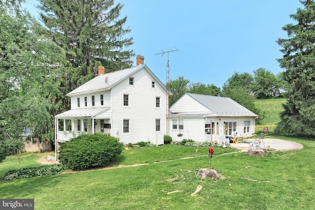 2241 Craley Rd, Windsor, PA 17366 - back of property with a yard, a chimney, metal roof, and a patio