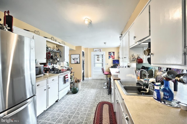 2241 Craley Rd, Windsor, PA 17366 - kitchen with stainless steel appliances, a sink, light countertops, and white cabinetry