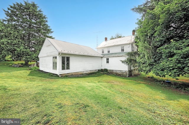 2241 Craley Rd, Windsor, PA 17366 - back of property with a chimney, a yard, and metal roof