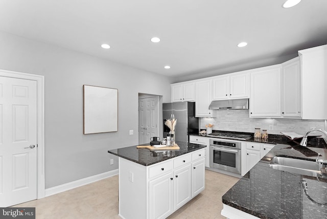 41311 Silverside Dr, Leesburg, VA 20175 - kitchen featuring appliances with stainless steel finishes, a sink, under cabinet range hood, white cabinetry, and recessed lighting