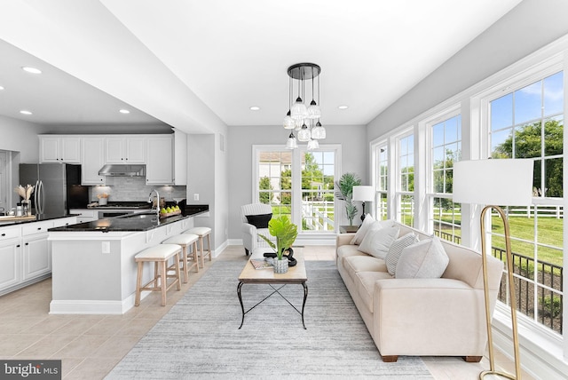 41311 Silverside Dr, Leesburg, VA 20175 - living area featuring light tile patterned floors, recessed lighting, baseboards, and a chandelier
