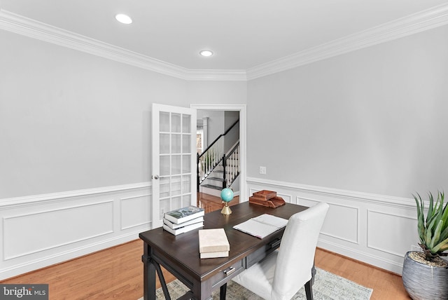41311 Silverside Dr, Leesburg, VA 20175 - dining space with crown molding, light wood finished floors, stairway, wainscoting, and recessed lighting