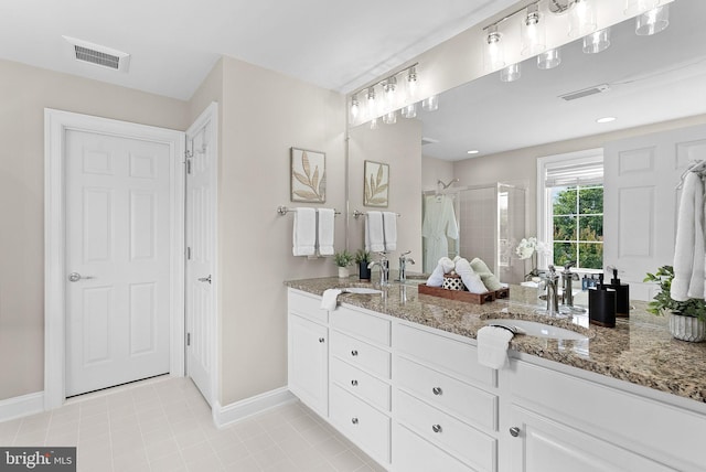 41311 Silverside Dr, Leesburg, VA 20175 - bathroom with double vanity, a shower stall, baseboards, and tile patterned floors