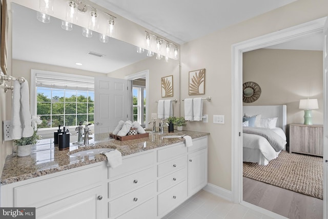41311 Silverside Dr, Leesburg, VA 20175 - ensuite bathroom with double vanity and baseboards