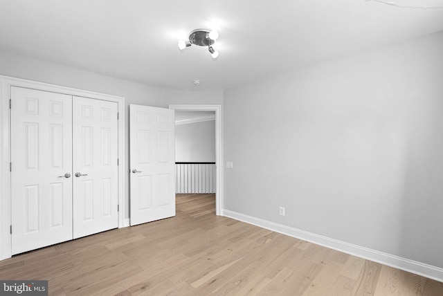 41311 Silverside Dr, Leesburg, VA 20175 - unfurnished bedroom with light wood finished floors, baseboards, and a closet